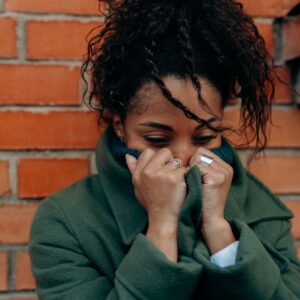 woman sad with face in hoodie