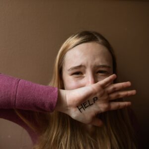 girl crying with help on her hand
