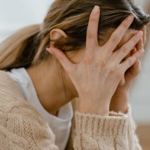 woman with head in hands