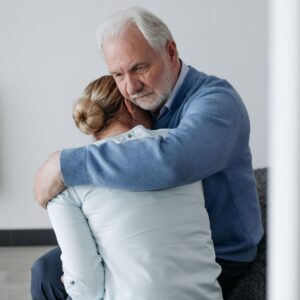older man hugging younger daughter